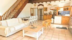 a living room with a couch and a table at Maison Aqua Bella - Terrasse - BBQ - 8pers in Contes