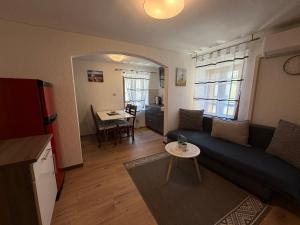 a living room with a couch and a table at Adria Pearl Appartments in Vrsar