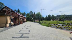 an empty road next to a building with the word eat at Czarny Koń i Biały Koń Black Horse & White Horse Apartamenty in Kamienna Góra