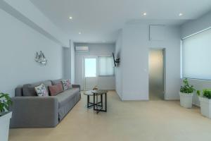 a living room with a couch and a table at Aspasia House in Platanias