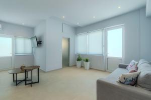 a living room with a couch and a table at Aspasia House in Platanias +63 photos