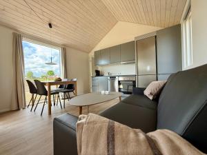 a living room with a couch and a table at Feriebyens Spahuse in Rødvig