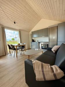 a living room with a couch and a table at Feriebyens Spahuse in Rødvig