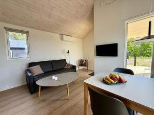 a living room with a couch and a table at Feriebyens Spahuse in Rødvig
