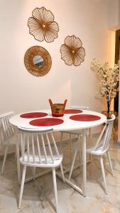 a white table with two chairs and two mirrors at Cherry Blossom Apartment in Xanthi