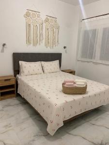 a bedroom with a bed with a basket on it at Cherry Blossom Apartment in Xanthi