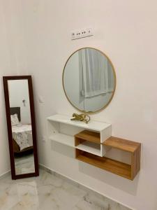 a mirror on a wall next to a white wall at Cherry Blossom Apartment in Xanthi