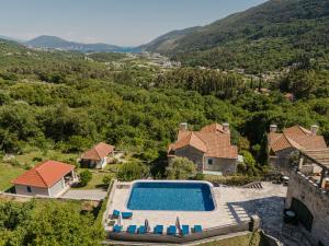 an aerial view of a house with a swimming pool at Lavender house with shared pool in Herceg-Novi