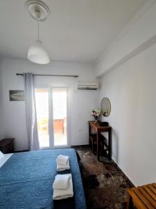 a bedroom with a bed and a mirror and a window at Anna Garden Sidari in Sidari