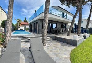 a home with a swimming pool and a house at Villa Borik in Vrsi