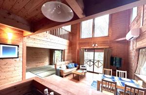 a living room with a couch and a table at Lodge Kurokawa 2 Forest in Minamioguni