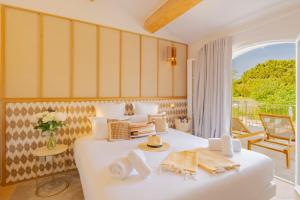 a bedroom with a large white bed and a balcony at Lou Saint-Tropez in Saint-Tropez