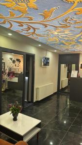a lobby with a ceiling with a dragon painted on it at Blue class otel in Atakum