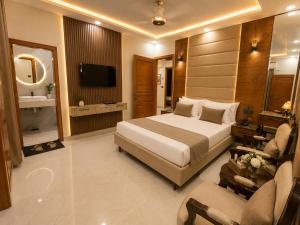 a hotel room with a bed and a television at City rooms in Karachi