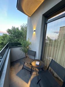 a balcony with two chairs and a table at MOCCA Lux Suite in Bitola