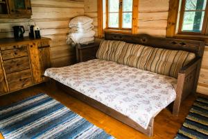a couch in a room in a log cabin at Sauna house with minilake in Voki
