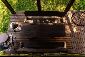 a group of benches sitting on a wooden deck at Sauna house with minilake in Voki