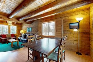a dining room with a table and chairs at Twin View Log Home in Carroll