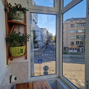 a window with a view of a city street at Blue Dreams - City Center Burgas in Burgas