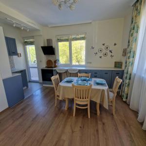 a kitchen and dining room with a table and chairs at Blue Dreams - City Center Burgas in Burgas