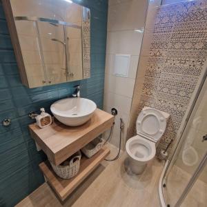a bathroom with a sink and a toilet and a shower at Blue Dreams - City Center Burgas in Burgas +18 photos