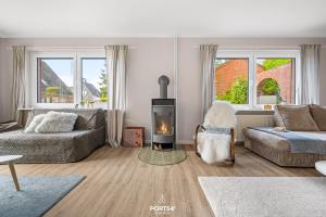 a living room with a couch and a fire place at Ferienwohnung Windjammer 5 St Peter-Ording in Sankt Peter-Ording
