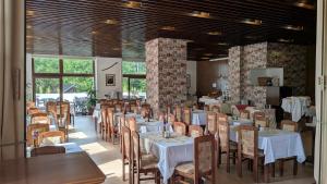 a dining room with white tables and chairs at Resort Hotel Zvíkov in Zvíkovské Podhradí