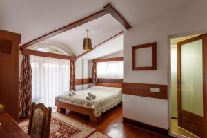 a bedroom with a bed and a window at Boutique Hotel 89 in Peje