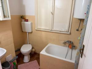 a bathroom with a toilet and a bath tub at Rooms delux muro in Split