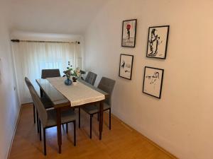 a dining room with a table and chairs at Rooms delux muro in Split