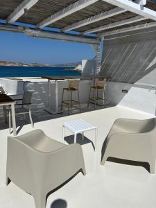 a room with tables and chairs on a boat at Pelekouda Coastal Apartments in Pollonia