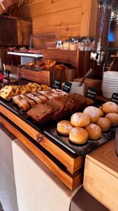 a display of donuts and pastries on a counter at Appartamento Arisch in Aprica