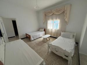 a hospital room with two beds and a window at Charmante maison à Hammamet, proche plage et commodités in Hammamet