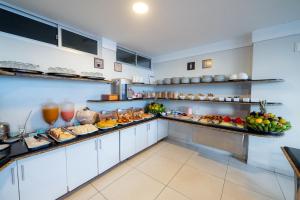 a large kitchen with a lot of food on display at Hotel Pousada Costa do Atlântico in João Pessoa