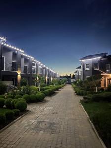 an empty driveway in front of houses at night at Sea Cloud Hotel in Zatoka