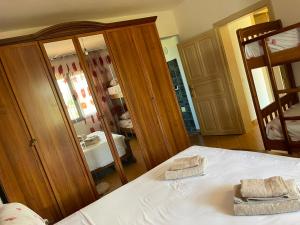 a bedroom with a bed and a large mirror at Mekli Guesthouse in (( Shën Ded Gjoni ))