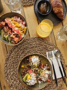 a wooden table with two plates of food on it at Yucca mini boutique hotel - Adults only in Jan Thiel +29 photos