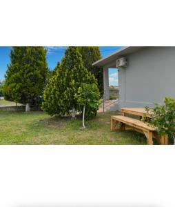 a picnic table and a tree next to a building at Mekli Guesthouse in (( Shën Ded Gjoni )) +17 photos