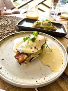 a plate with a breakfast sandwich on a table at Yucca mini boutique hotel - Adults only in Jan Thiel