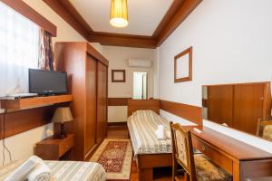 a small room with a desk and a television at Boutique Hotel 89 in Peje