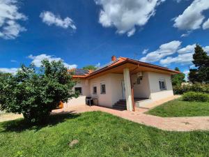 a small white house with a roof at Barlang utca Villa in Cserszegtomaj