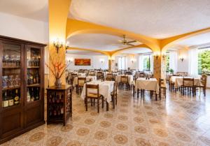 a restaurant with tables and chairs in a room at Hotel Aragonese Ischia in Ischia Town