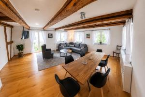 a living room with a wooden table and chairs at Casa Anno 1782 in Markdorf