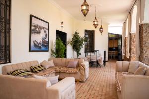 a living room with couches and a dining room at Nassau House Marrakech in Mellah Bakka