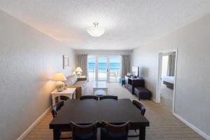 a living room with a table and a couch at The Sea Ranch Resort in Kill Devil Hills