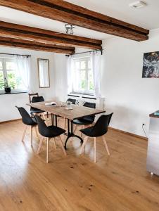 a dining room with a wooden table and chairs at Casa Anno 1782 in Markdorf