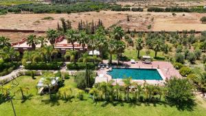 an aerial view of a resort with a pool and palm trees at Nassau House Marrakech in Mellah Bakka