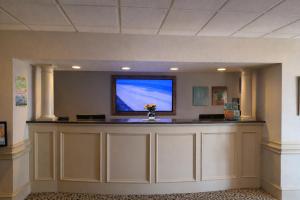 a waiting room with a counter with a tv on the wall at The Sea Ranch Resort in Kill Devil Hills