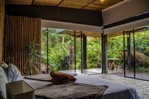 a bedroom with a bed in a room with glass doors at Glamping Salento in Salento