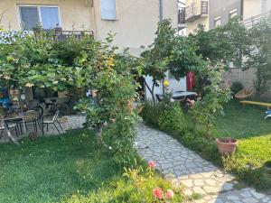 a garden with an orange tree and a patio at Camping Struga Macedonia in Struga